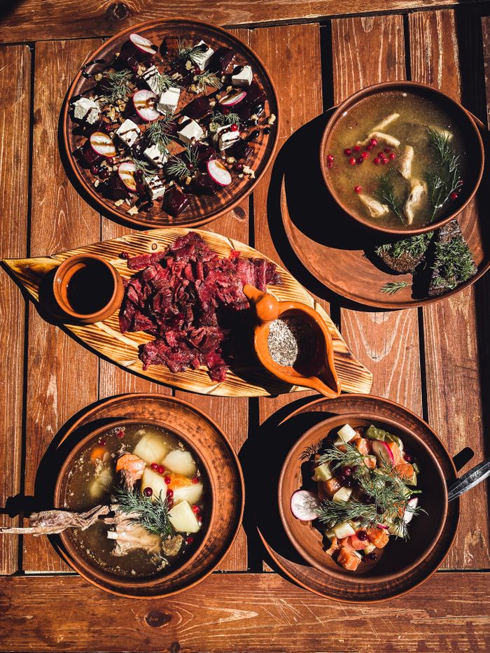 Home Delicious rustic Russian meal featuring traditional dishes served on wooden table. Captured in natural light.
